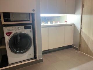 Laundry room with washing machine and cabinetry