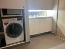 Laundry room with washing machine and cabinetry