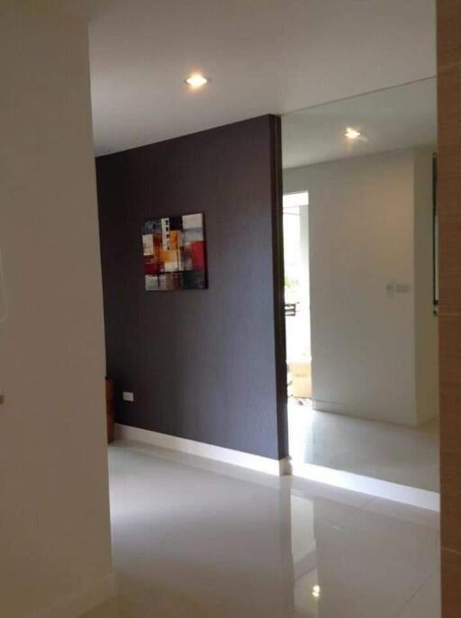 Modern hallway with large mirror and artwork