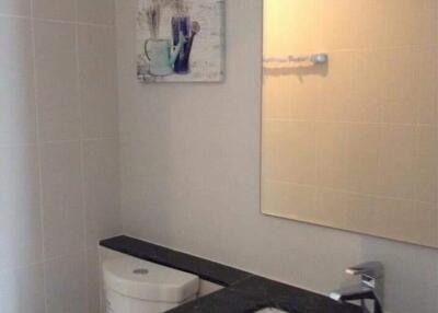 Bathroom with sink, mirror, and wall art