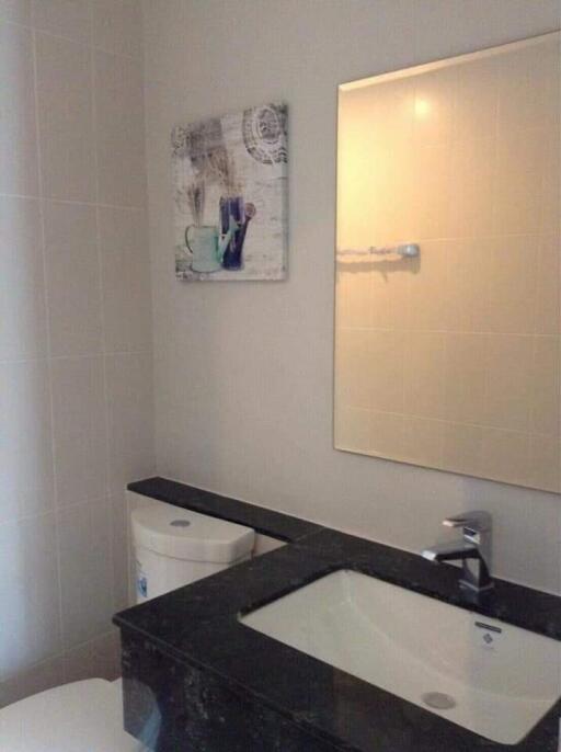 Bathroom with sink, mirror, and wall art