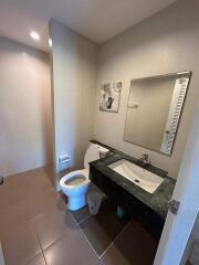 Modern bathroom with sink, toilet, and mirror