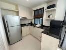 Modern kitchen with stainless steel appliances and black countertops