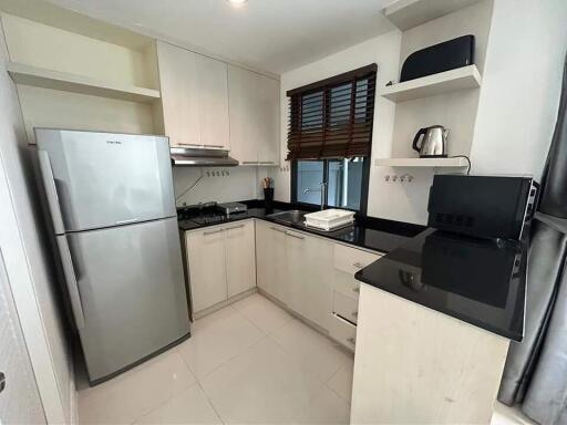 Modern kitchen with stainless steel appliances and black countertops