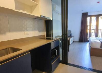 Open studio apartment with kitchenette and bedroom area