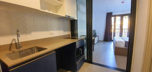 Open studio apartment with kitchenette and bedroom area