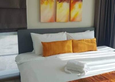 Modern bedroom with vibrant orange accents