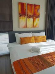 Modern bedroom with vibrant orange accents