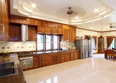 Spacious kitchen with wooden cabinets and modern appliances