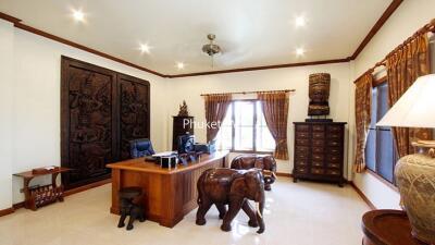 Home office with wooden desk and elephant-shaped chairs