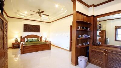 Spacious and well-furnished bedroom with wooden decor