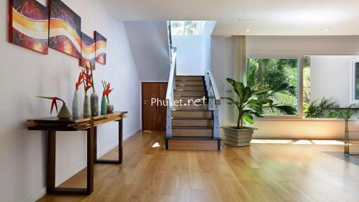 Modern hallway with staircase and large windows