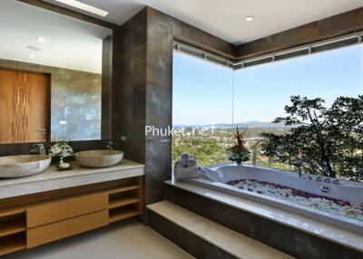 Luxurious bathroom with dual sinks and a scenic view from the bathtub