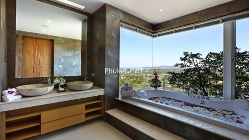 Luxurious bathroom with dual sinks and a scenic view from the bathtub