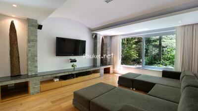 Modern living room with large window and grey sectional sofa