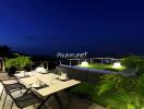 Outdoor terrace with patio furniture and city view at night