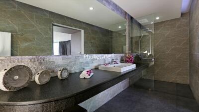 Modern bathroom with large mirror and stone decor