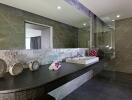 Modern bathroom with large mirror and stone decor