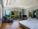 Spacious bedroom with large windows and balcony view