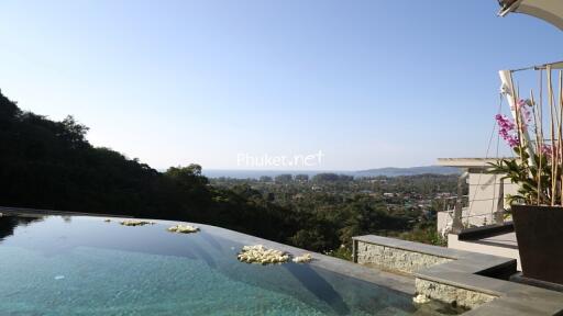 Scenic view from a pool-side area with surrounding greenery