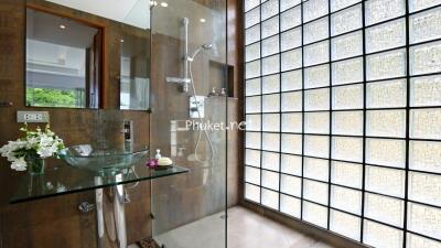 Modern bathroom with glass shower and glass sink