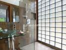 Modern bathroom with glass shower and glass sink