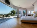 Spacious bedroom with large windows and scenic view