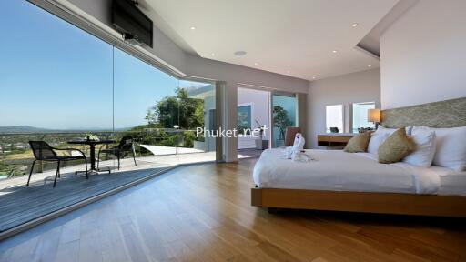 Spacious bedroom with large windows and scenic view