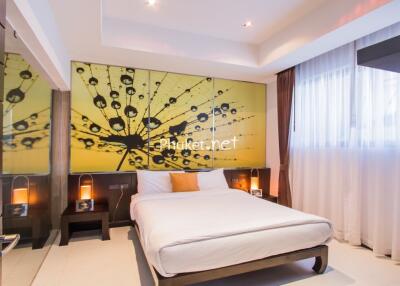 Modern bedroom with large window and abstract wall art