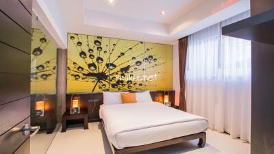 Modern bedroom with large window and abstract wall art