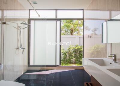 Modern bathroom with large windows and glass shower