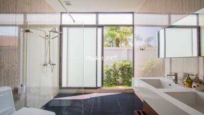 Modern bathroom with large windows and glass shower