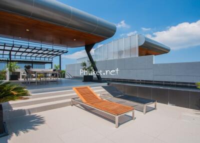 Modern rooftop terrace with seating and lounge chairs