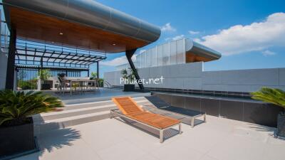 Modern rooftop terrace with seating and lounge chairs