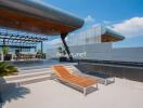 Modern rooftop terrace with seating and lounge chairs