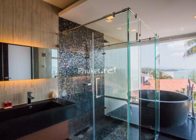 Luxurious bathroom with glass shower and scenic view