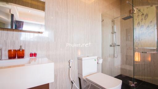 Modern bathroom with glass shower and white fixtures