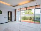 Modern bedroom with large windows and garden view