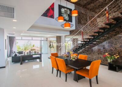 Spacious modern living and dining area with staircase