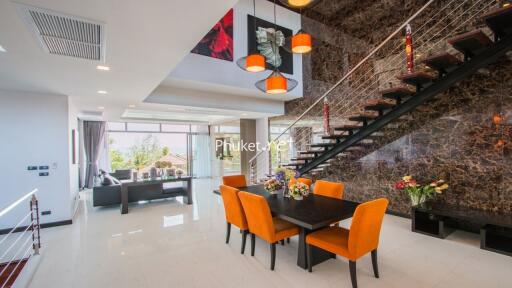 Spacious modern living and dining area with staircase