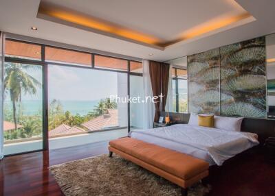 Spacious bedroom with large windows and ocean view