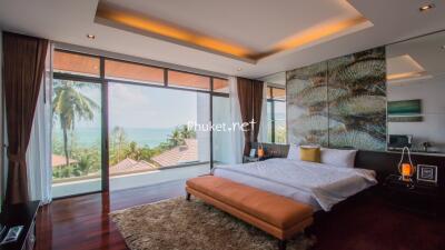 Spacious bedroom with large windows and ocean view