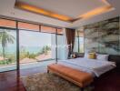 Spacious bedroom with large windows and ocean view