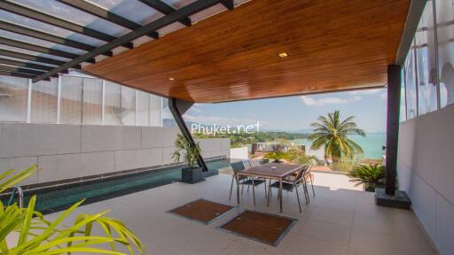 Outdoor balcony with dining area and ocean view