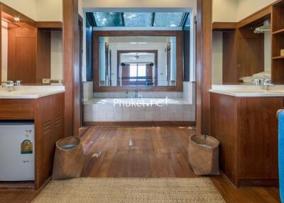 Spacious double bathroom with wooden cabinets and large mirrors