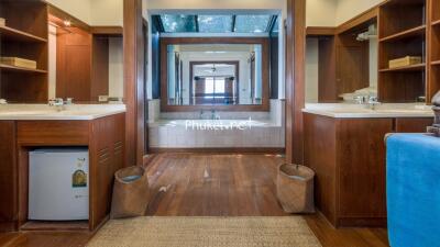 Spacious double bathroom with wooden cabinets and large mirrors