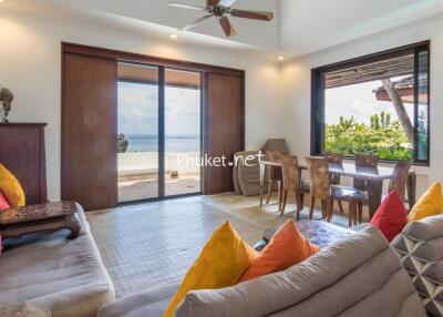 Well-lit living area with ocean view and colorful cushions