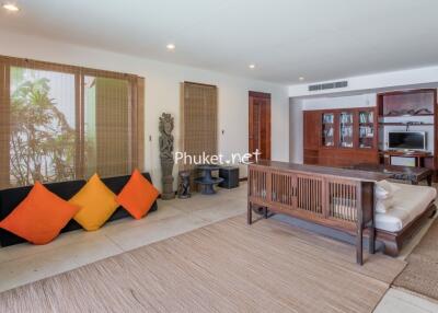 Spacious living room featuring comfortable wooden furniture and vibrant decorative elements