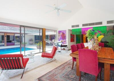 Bright open living and dining area with pool view