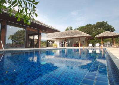 Outdoor pool with adjacent buildings and greenery